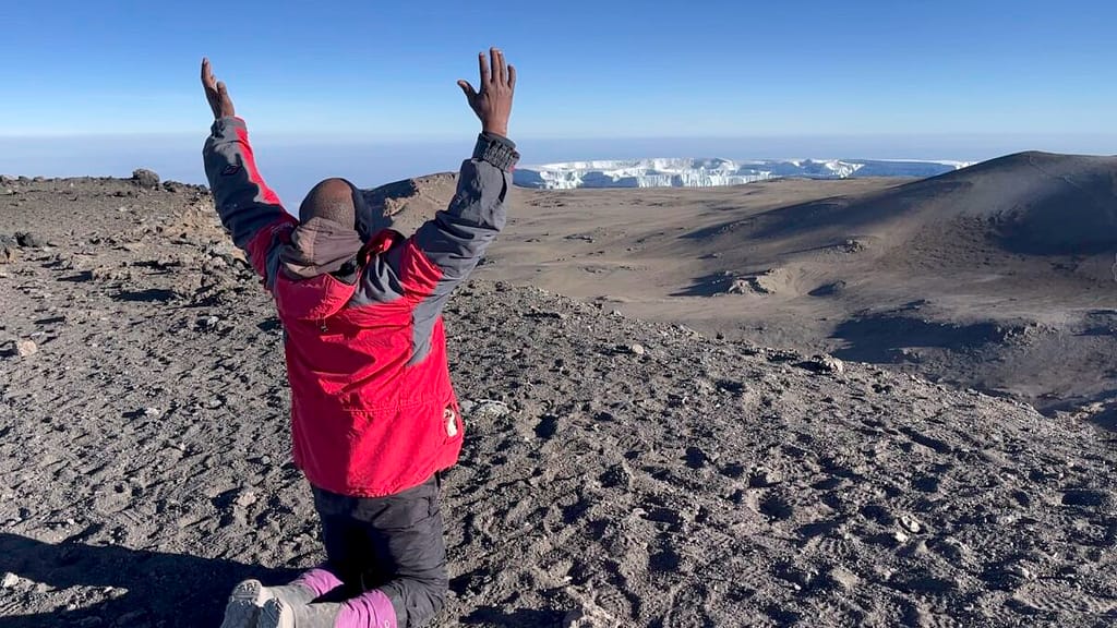 Missionary praying and sharing the Gospel on a mountain, symbolizing faith, obedience, and taking God’s Word to remote places.